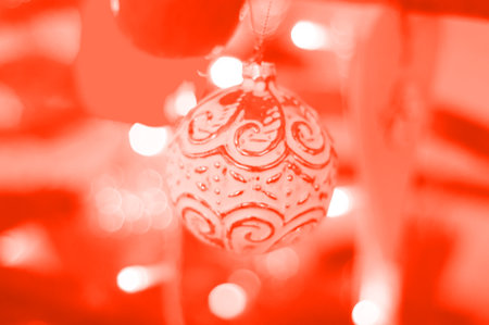 Blurred background of Christmas garland lights in living coral. Warm and sparkle.の写真素材