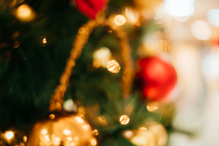 Bright abstract Christmas background with blurred lights and Christmas tree decoration.の写真素材