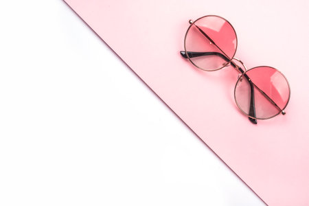 Round gradient sunglasses on the beautiful pink and white background.の写真素材