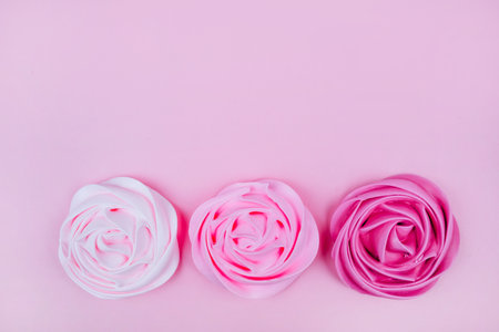 Beautiful pink and magenta gradient with rose flower shaped meringue flatlay.の写真素材