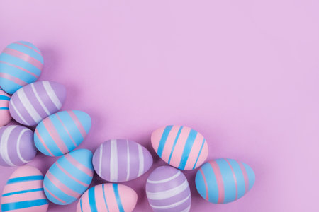 Dyed on blue, pink and violet Easter eggs isolated on purple background. Easter theme flatlay.