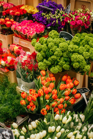 Beautiful orange tulips, peonies and ranunculus flower bouquet and others. Spotted on the flower market.の写真素材