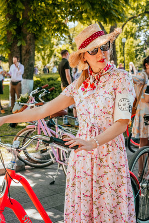 Kiev, Ukraine - May 19, 2019: Girl in pink vintage dress participating in bicycle tweed run Retro Cruise in Kiev, Ukraine.のeditorial素材