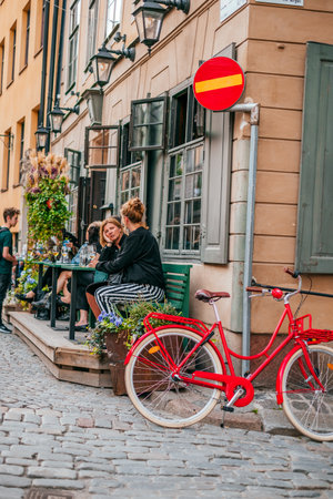 Stockholm, Sweden - June 29, 2019: Cafe terrace in the old narrow streets of Stockholms old town Gamla Stan.のeditorial素材