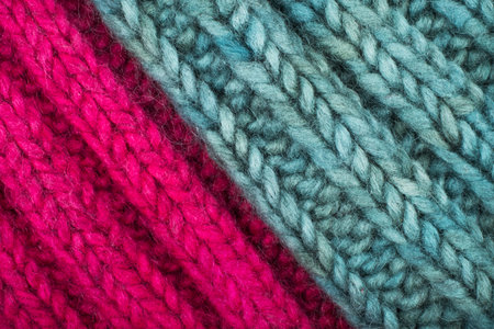 Cozy background of green and magenta knitwear texture details.の写真素材