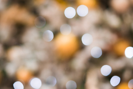 Abstract background with golden glitter bokeh lights.の写真素材