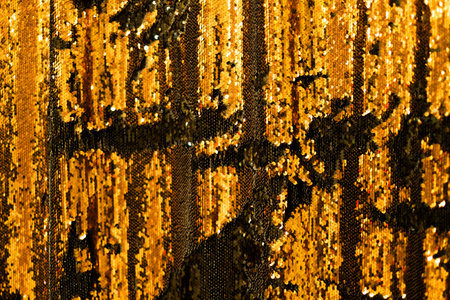 Gold glitter textile background. Color of the year concept.の写真素材
