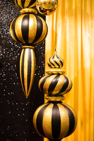 Gold and black spiral Christmas tree decoration with bokeh lightening background.の写真素材