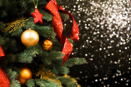 Christmas tree decoration and garland with golden bokeh lightening background.の写真素材