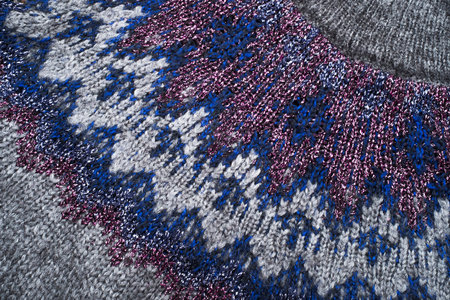 Grey knitwear texture with ornament details.