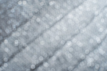 Silver shiny fabric background. Christmas inspired textile.の写真素材