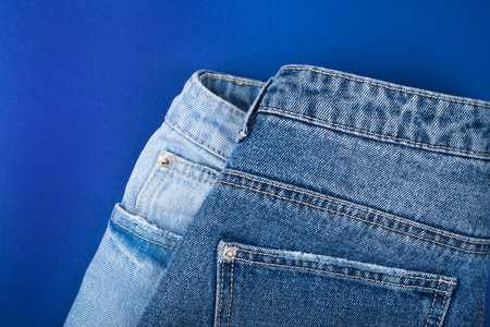 Pair of jeans isolated on blue background.の写真素材