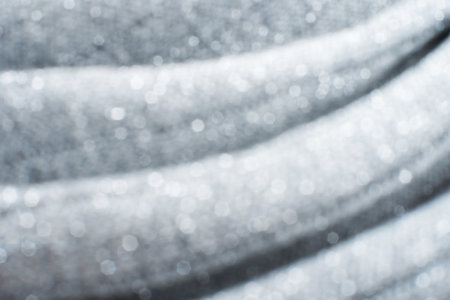 Silver shiny fabric background. Christmas inspired textile.の写真素材