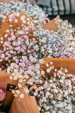 Beautiful bouquet of mixed gypsophila paniculata baby's breath flowers spotted on the flower market.の写真素材