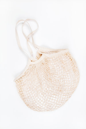 Flatlay with mesh string produce bag isolated on white background. Zero waste concept.の写真素材