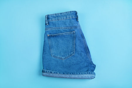 Sport inspired flatlay with denim shorts isolated on blue background.の写真素材