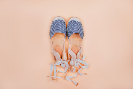 Summer fashion flatlay with striped espadrilles sandals isolated on beige background.の写真素材