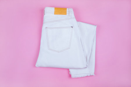 Summer fashion flatlay with white denim jeans isolated on pink background.の写真素材