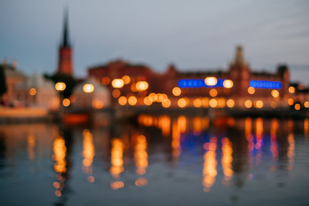 Blurred background of Stockholm city at night. Cityscape lights captured with reflection on the river.の写真素材