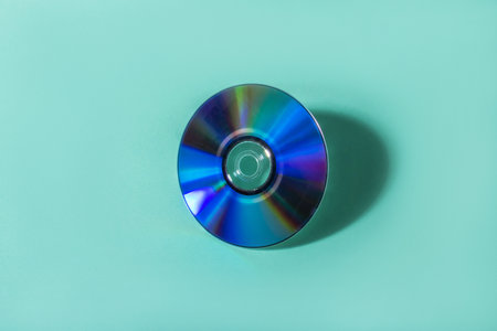 Flatlay with purple compact disc isolated on turquoise background.の写真素材