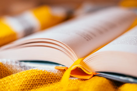 Trendy fall flatlay with yellow sweater and book.の写真素材