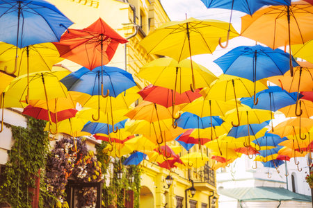 Beautiful street decorated with colorful yellow, blue and red umbrellas.の写真素材