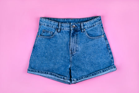 Sport inspired flatlay with denim shorts isolated on pink background.の写真素材