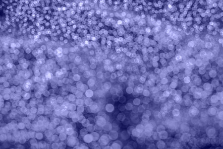 Violet abstract background with soft glitter bokeh lights.の写真素材