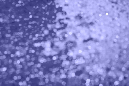 Abstract background with violet glitter bokeh lights.の写真素材