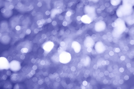 Abstract background with violet glitter bokeh lights.の写真素材