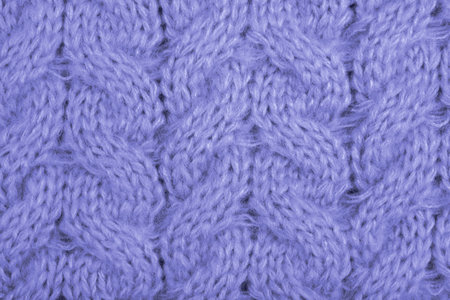Cozy background of violet knitted texture with cables and braids.の写真素材
