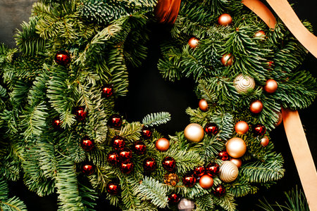 Beautiful Christmas wreath with garland and baubles decoration isolated on black background.の写真素材