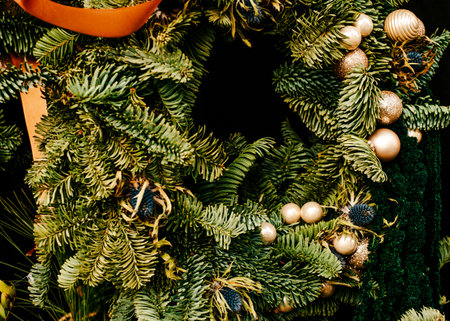 Beautiful Christmas wreath with garland and baubles decoration isolated on black background.の写真素材