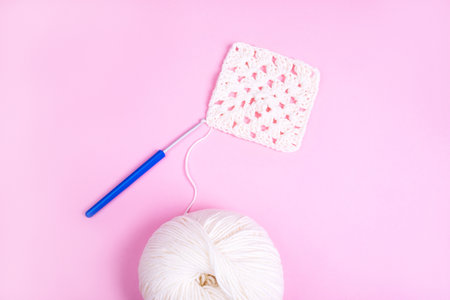 Closeup background of crochet knitting in progress and multicolored yarn balls.の写真素材
