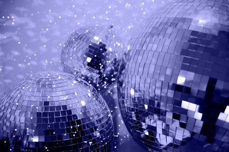 Violet colored party disco ball baubles on violet background.の写真素材