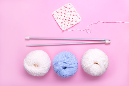 Closeup background of crochet knitting in progress and multicolored yarn balls.の写真素材