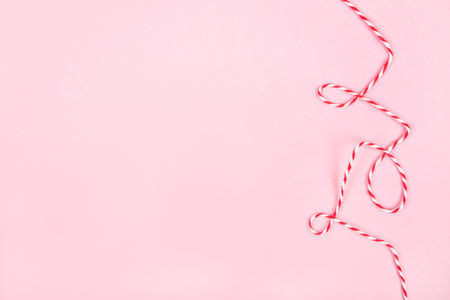 Christmas string or red and white striped twine isolated on pink background.の写真素材