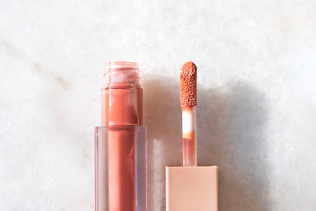 Trendy shade of pink lip gloss on marble background.の写真素材
