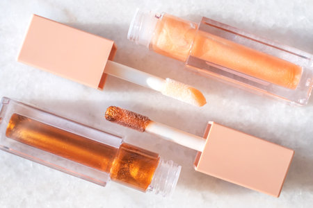 Trendy shade of pink lip gloss on marble background.の写真素材