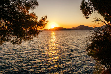Amazing and quiet sunset on the beach with a mountain view.の写真素材