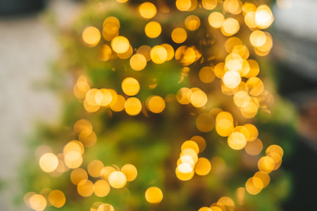 Abstract background with golden glitter bokeh lights.の写真素材