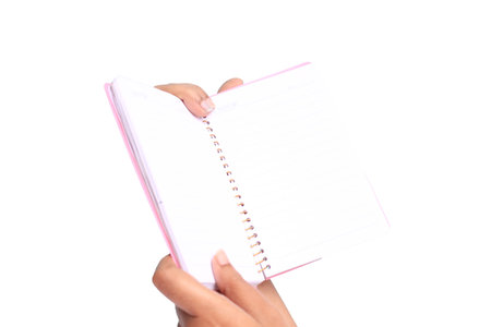 hand is showing a book on white background