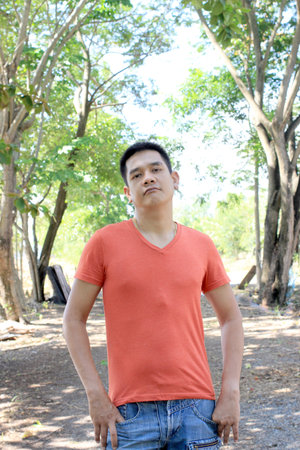 Man is standing in the park on nature backgroundの写真素材