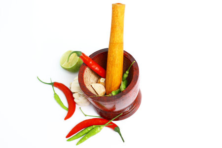 mortar and ingredients for cooking on white background with space for textの写真素材