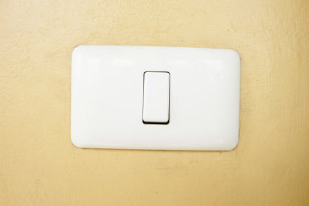 Electronic Switch on yellow wall backgroundの写真素材