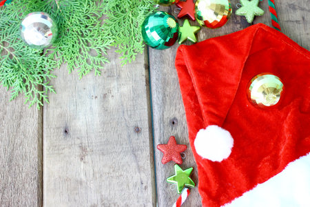 Santa's hat and Christmas accessories on wooden background and copy spaceの写真素材