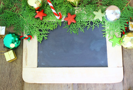 Beautiful Christmas decoration and chalkboard on wooden backgroundの写真素材