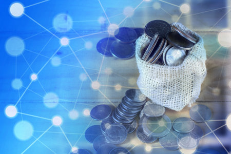 Overflow money very much from bag on wood ground. Conceptual internet can make money become millionaire.の写真素材