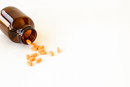 Many drugs overflow from the bottle on a white background. Vitamin cの写真素材