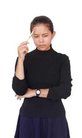 A Beautiful woman wore a black blouse with a blue skirt holding a white pen and serious thinking...